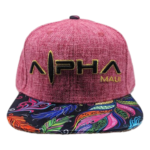 A red textured snapback hat named "Feathers" with the text "Alpha Maui" embroidered in yellow thread on the front panel. The brim features a vibrant feather pattern in shades of purple, orange, blue, and green, embodying the colorful spirit of Hawaii's Ohana.