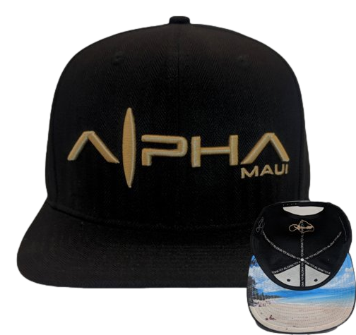A black baseball cap named the Baldwin Beach Bro showcases the "Alpha Maui" logo on the front panel, which features a stylized surfboard design. Next to the cap is its underside, revealing a colorful beach scene complete with a lighthouse and a logo displaying crossed surfboards—making it an ideal piece of Aloha-inspired beach apparel.