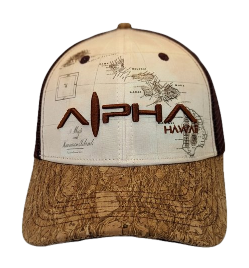 The Alpha Maui Wailea Islander is a beige and brown hat with intricate embroidered details. The front prominently features "Alpha Hawaii" in brown stitching. The light brown fabric on the front showcases a map-like design, while the brim is adorned with a textured, wood-like pattern. This hat, ideal for beachwear, also includes a mesh back for added comfort and style.