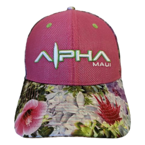 The Alpha Maui Garden Bouquet II is a pink baseball cap with a floral-patterned brim embodying the spirit of Hawaii. The cap features "Alpha Maui" in white and green embroidered letters, and the floral pattern, reminiscent of an Aloha paradise, includes tropical flowers in shades of pink, red, and green.