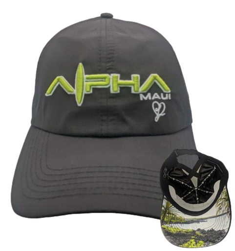A dark gray baseball cap called "Sea Arch" with "Alpha Maui" embroidered in green and white on the front. The underside of the brim features a detailed tropical island graphic with palm trees and an ocean view, radiating true Aloha spirit.