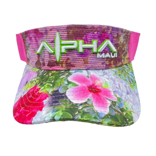 The Alpha Maui Drop Top Garden Bouquet is a vibrant visor adorned with a floral design showcasing pink and white flowers alongside green leaves. The front proudly displays "Alpha Maui" in bold, green letters, separated by an artistic line and dot pattern. The mostly pink background effortlessly captures Hawaii's Aloha spirit.
