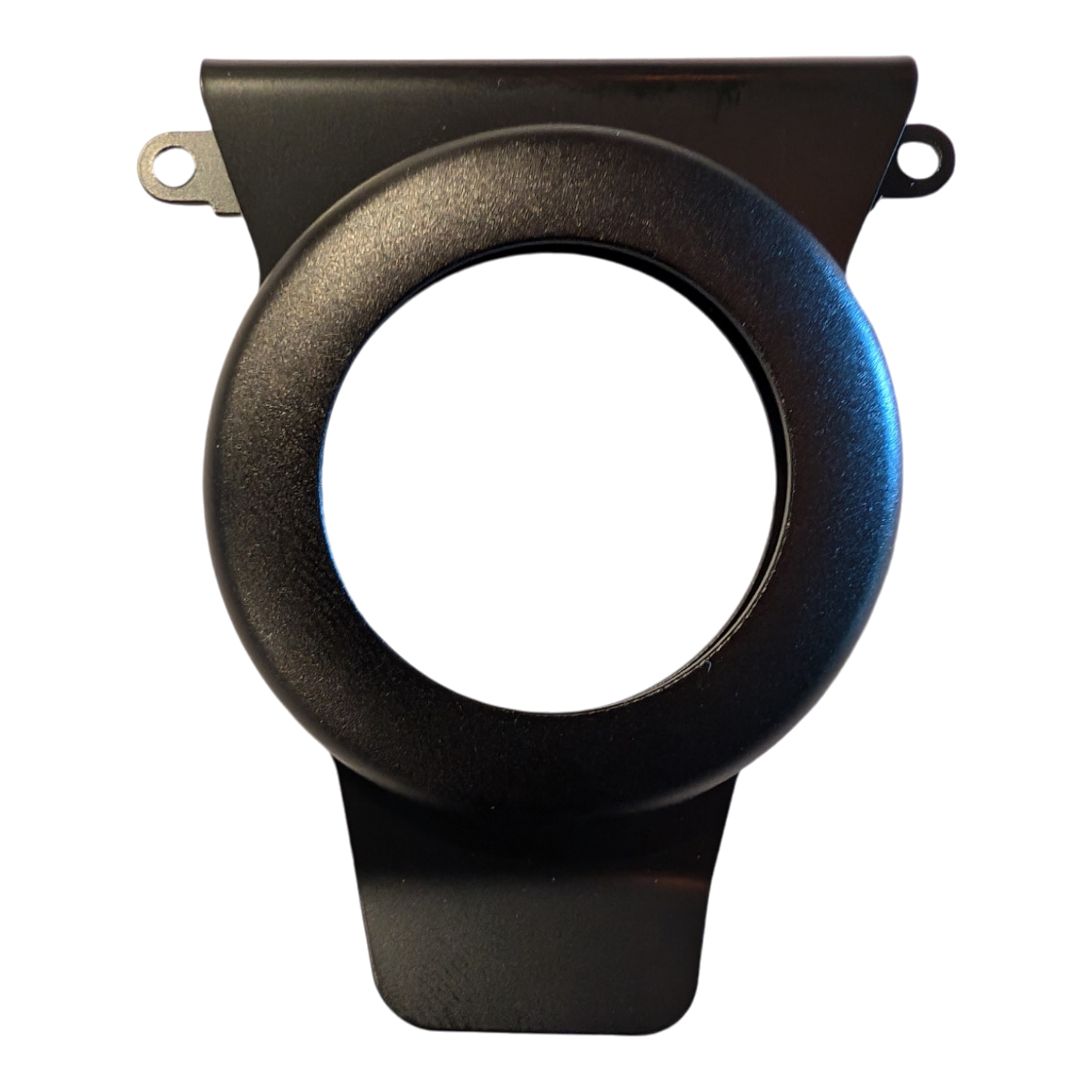 Close-up of a component from the Alpha Air Tag kit, which is a black, circular plastic piece with two small tabs protruding from the top. It features a central hollow circular section and seems to be designed for a specific mechanical or electronic application. The background is black.