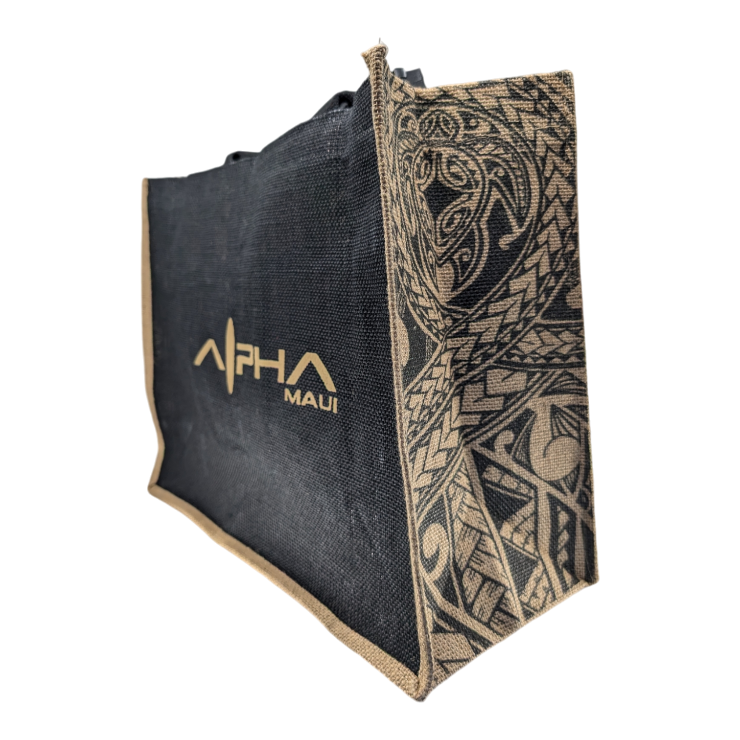 A black and beige Alpha Maui tote bag with decorative patterns on the side. The bag features the brand's logo and intricate designs, showcasing a blend of modern style and traditional motifs.