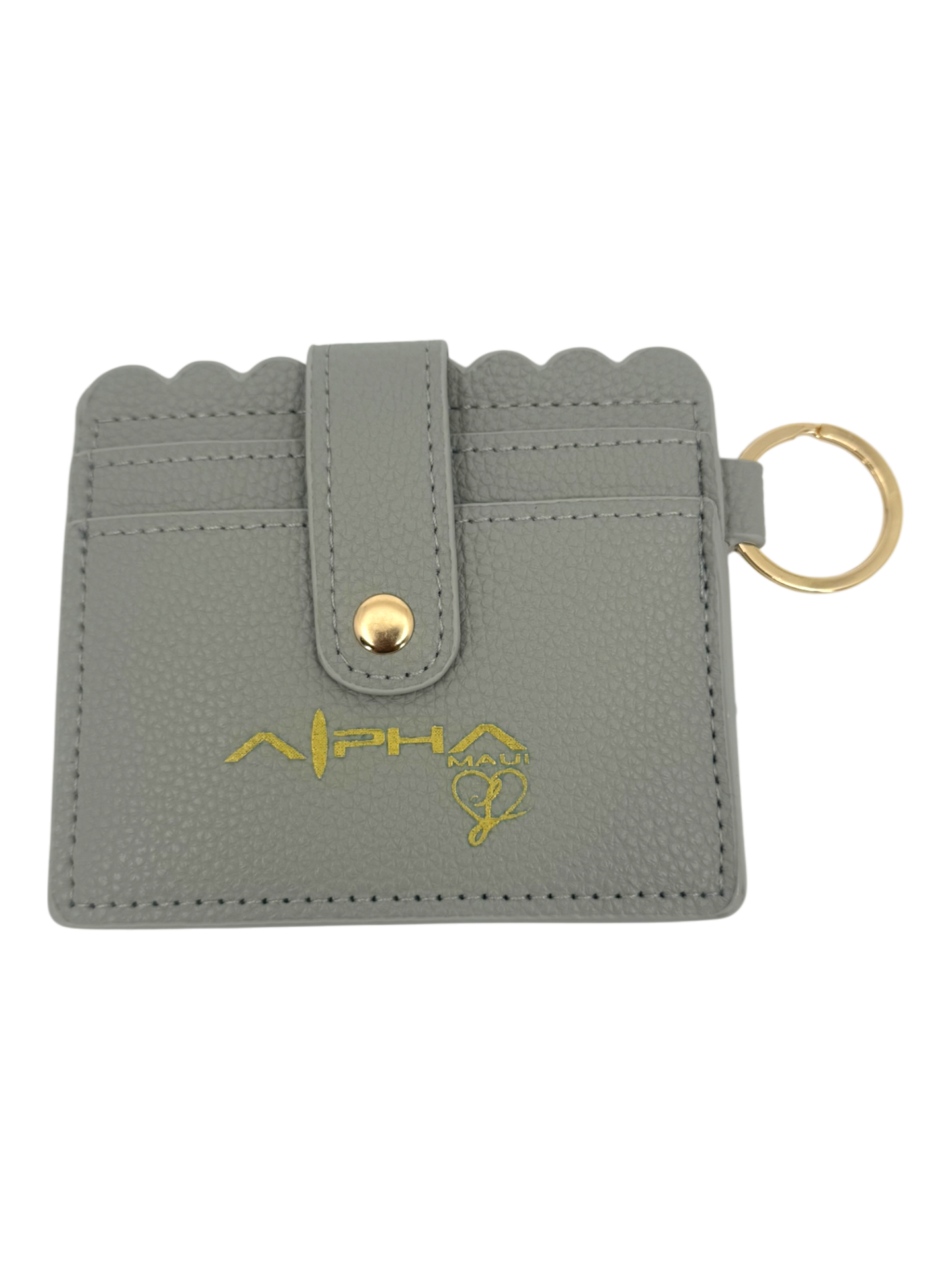 A gray textured cardholder with a scalloped edge, gold snap button, keyring, and gold "ALPHA" logo with a paw print design on the front.