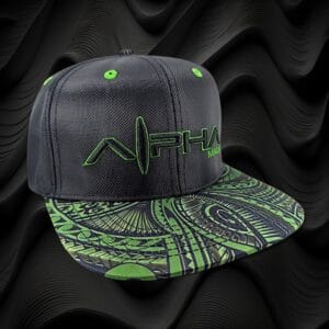 A black snapback hat with "ALPHA" embroidered in green and a stylized green logo. The brim features an intricate green and black abstract pattern. The background has a wavy, black textured design.
